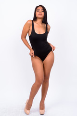 Young Asian woman wearing swimwear against white background