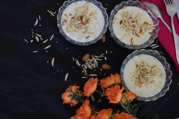 Rice pudding(kheer) with sprinkled almonds, space to add text