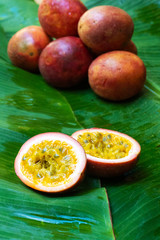 Ripe passion fruit, on a wet banana leaf. Vitamins, fruits, healthy foods