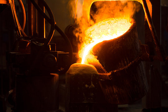 The molten liquid metal is poured into the mold.