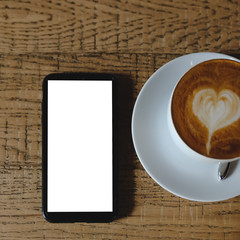 Top view empty white coffee cup (latte coffee) and smartphone.