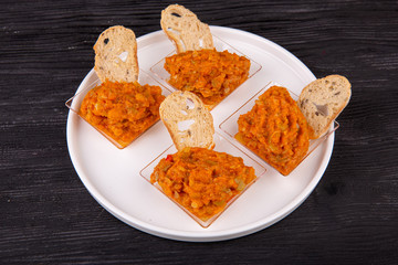 Caviar made of eggplant with vegetables, served with toast made of black bread
