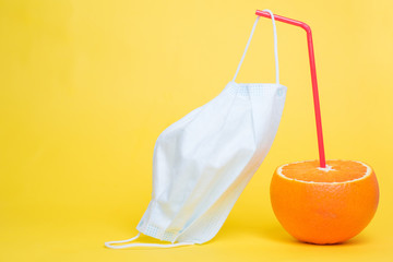 orange with straws and medical mask