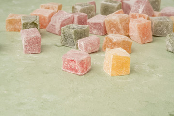 clseup colorful Turkish delights on green background