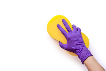 hand with glove holding yellow sponge for cleaning isolated on white background.
