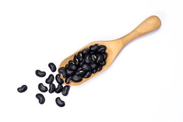 black beans in wooden scoop isolated on white. Top view. 