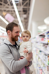  Dad with   child buying products in   store.