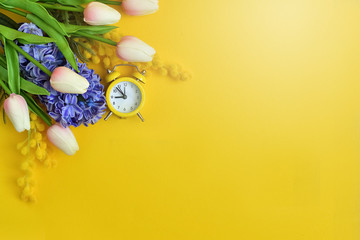 Spring flowers, blue Hyacinth , tulips and mimosa on yellow background. Spring mood. Spring card.picture for packages