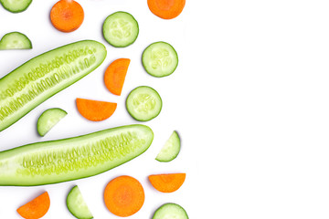 Cucumber and carrot cut sliced isolated on white background. Beauty and spa products concept. Top view. Flat lay. Copy space for text.