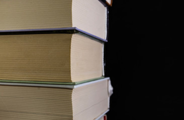 stack of books on a black background, close-up. Education concept. Time to go to school. copy space.