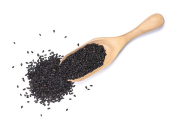 Closeup black sesame seeds in wooden scoop isolated on white background. Healthy eating concept. Top view. Flat lay.