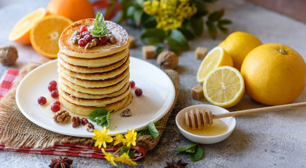 Delicious fresh beautiful pancakes with citrus honey and jam