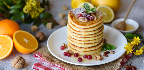 Delicious fresh beautiful pancakes with citrus honey and jam