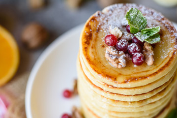 Delicious fresh beautiful pancakes with citrus honey and jam