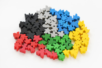 Board game parts meeples in groups concept on white backgorund
