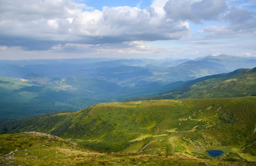 Fototapeta na wymiar Cloudy sky and perfect look on Mountain lake Ivor and valley Dragobrat on Svydovets ridge. Carpathians, Ukraine, 
