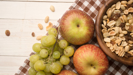 fruits and muesli on a wooden background