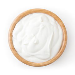 Sour cream in wooden bowl isolated on white background with clipping path