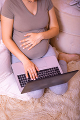 Mother pregnancy working online in home office, pregnant mom typing keyboard laptop computer. Coronavirus or covid-19 ncov concept. Stay at home.