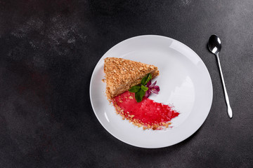 Fresh delicious cake napoleon with cream on a dark background