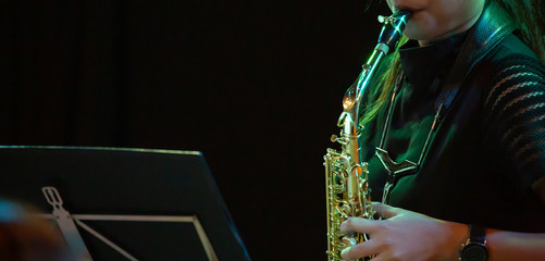 Musicians playing the saxophone in a jazz performance