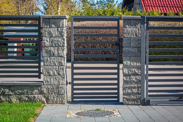 Stone fence and entrance gate with remote control - obrazy, fototapety, plakaty