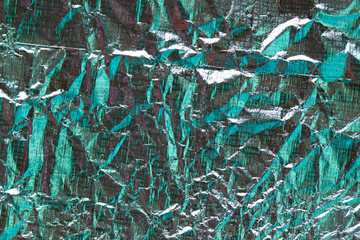 Crumpled silver metallic foil macro texture. Abstract metal background
