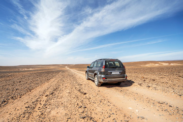 Obraz na płótnie Canvas Driving on dirt road through Sahara desert, Morocco