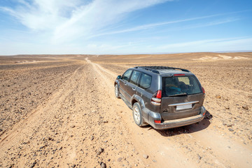 Fototapeta na wymiar Driving on dirt road through Sahara desert, Morocco