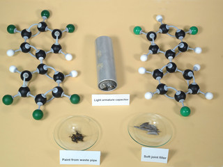 Molecule models of two variants of PCB - polychlorinated biphenyl, a retired toxic ingredient in building elements and some material samples. White is Hydrogen, black is Carbon, and Green is Chlorine.
