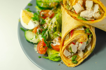 Chilli tortilla wrap with chicken breast, peppers, cucumber and mix salad