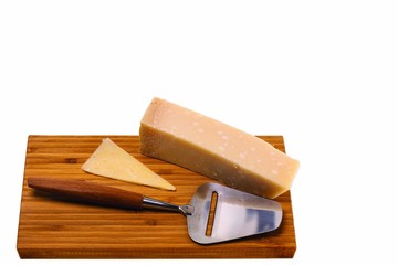 Close up view of different kinds of cheese with cheese knife isolated on wooden board. Healthy food concept.