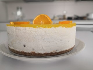 A detail of An orange cheesecake