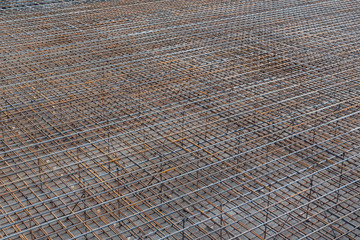 Industrial background. Reinforcement bars for pouring the foundation of a multi-story building
