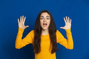 Brunette young girl wearing yellow jersey