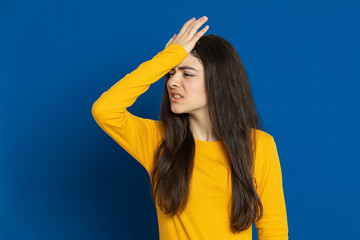 Brunette young girl wearing yellow jersey