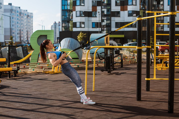Fototapeta premium Concentrated beautiful female intensive workout with power effort outdoor leisure, strong motivated young woman self control achievement activity summer sunny positive sport fitness content