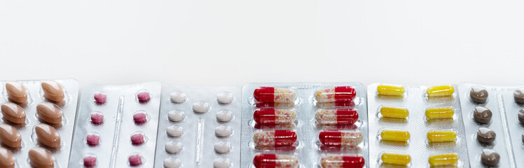 Vitamins and pills blister packs, close-up.