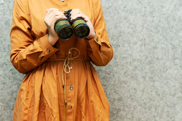 woman holding  military old binocular, Discovery Equipment. Columbus Day Concept. 