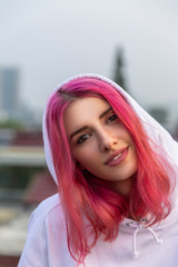 portrait of a girl with pink hair on the roof