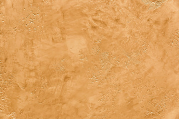 Texture of light orange stone wall with abstract pattern colored stucco wallpaper background tile