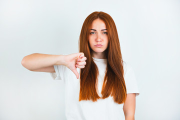 portrait of redheaded young woman looking natural standing on isolated white backgroung showing...