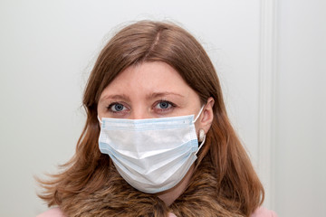 Close-up of woman wearing an anti-virus protection mask to prevent flu infection, allergies, virus protection, COVID-19, and corona virus pandemic disease 2019