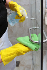 Cleaning the shower cabin. Macro photo. An unrecognizable photo. The concept of cleanliness and hygiene.