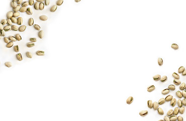 Roasted and salted pistachios in shell on white background with space for text. Top view, flat lay