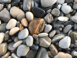 Fototapeta na wymiar Multiple pebbles on beach nature detail background