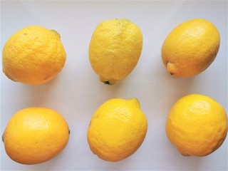 Lemons. 6 whole lemons on a white background. Top view. Fresh vitamin nutrition. Natural food. Isolated citrus fruit set