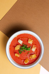 Homemade tomato soup with bread, mint and olive oil