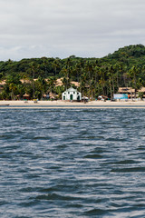 Fototapeta na wymiar a church in a tropical beach with boats