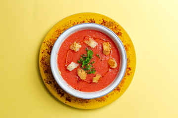 Homemade tomato soup with bread, mint and olive oil